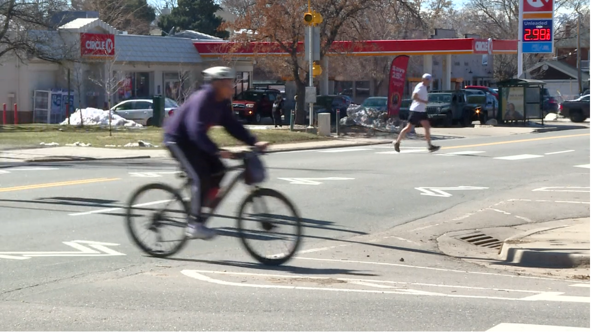 Biker and runner crossing Alameda Avenue